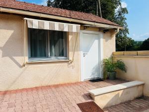 a house with a white door and a potted plant at Les Ouches in Fleurey-sur-Ouche