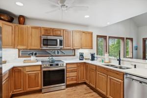 a kitchen with wooden cabinets and stainless steel appliances at Wycham Place in Boone