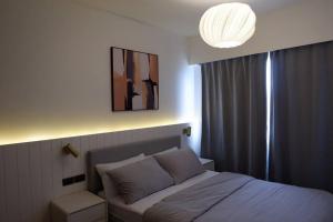 a bedroom with a bed and a picture on the wall at Modern Nordic 1 Bedroom Condo near Eastwood, Quezon City in Manila