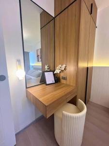 a bathroom with a desk with a toilet and a mirror at Modern Nordic 1 Bedroom Condo near Eastwood, Quezon City in Manila