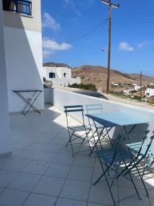 a table and chairs on a patio with a view at Sofianna's oasis in Kalloni Tinou