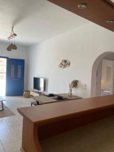 a living room with white walls and a counter top at Sofianna's oasis in Kalloni Tinou