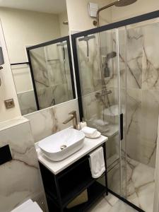 a bathroom with a sink and a shower at LIZA I Sea View in Lokva Rogoznica +10 photos