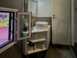 a bathroom with a sink and a mirror at La Maison de la Mer with Terrace and AC in Vernazza