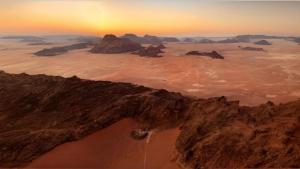 an aerial view of a desert at sunset at Wadi Rum Majestic Camp in Wadi Rum