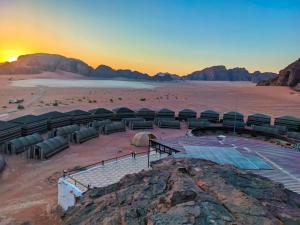 an amphitheater in the desert with a sunset at Wadi Rum Majestic Camp in Wadi Rum