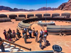 a group of people standing in the desert at Wadi Rum Majestic Camp in Wadi Rum