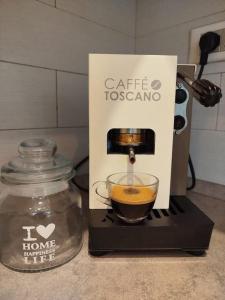 a coffee maker is making a cup of coffee at Appartamento al parco con parcheggio gratuito in Orbetello