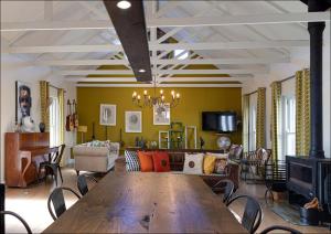 a living room with a wooden table and a couch at Pelicans Nest in Onrus in Hermanus