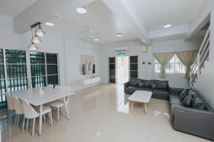 a living room with a couch and a table at Kings Pine Residences Lot 14 Big Group Homestay Near Kundasang Ranau in Ranau