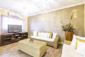 a living room with a couch and a tv at Auas City Hotel in Windhoek
