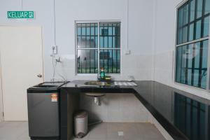 a bathroom with a sink and a mirror at Kings Pine Residence homestay 14 in Ranau +59 photos