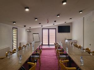a large room with a long table and chairs at Hotel Arena - Teteks in Tetovo