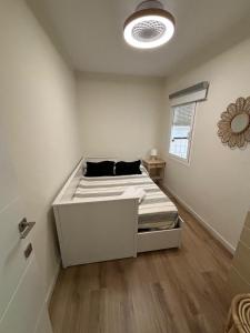 a white bedroom with a bed in a room at Greenhouse in Priego de Córdoba +8 photos