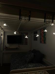 a bedroom with a bed and lights on the wall at Apart Centro-Playa Terraza in Barbate