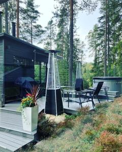 a house with two chairs and a table on a deck at Villa Falco in Espoo