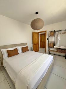 a bedroom with a large white bed in a room at Casa Spartea Cilento coast in Marina di Camerota