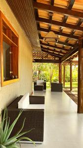 a patio with couches and tables and a wooden ceiling at Aloe Hotel Boutique in Prado +40 photos