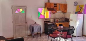 a kitchen with a table and chairs and a colorful window at Casa en uspallata in Uspallata
