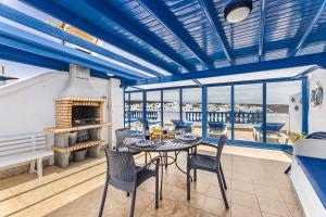 a dining room with blue ceilings and a table and chairs at Casa Azul by Escape Home in Punta de Mujeres