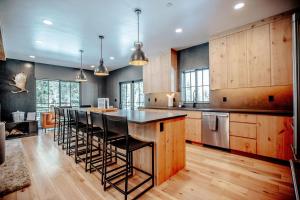 a kitchen with a island with bar stools at Stunning New Build! Xanadu - Private Luxury Home at Solitude Mountain Resort in Solitude