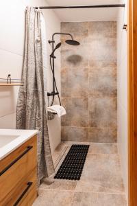 a bathroom with a shower and a sink at Panorama Górska Wisła Resort & SPA in Wisła