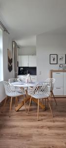 a kitchen with a table and chairs in a room at Pension Schul Inn in Ruhla