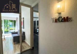 a living room with a chair and a mirror at T3 - WELCOME - Cluses in Cluses +6 photos
