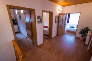 a hallway with two doors and a room with a bedroom at Cuibul Zăganului - Relax, Sauna & SPA in Cheia