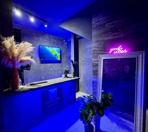a bathroom with a sink and a neon sign at Zyan Rooms in Villahermosa