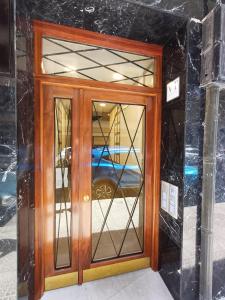 a wooden door with glass windows on a building at Modern apartment near to Guggenheim museum in Bilbao