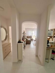 a living room with an archway into a room with a couch at Honduras 11alto in Roquetas de Mar