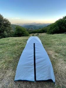 a blue tent sitting on top of a field at Camping à la ferme in Saint-Germain-de-Calberte