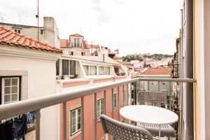 a balcony with chairs and a view of the city at Rossio Studios in Lisbon