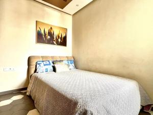 a bedroom with a large bed in a room at Appartement HAY SALAM Agadir in Agadir