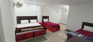 a bedroom with a bed and a chair in it at Mohit Guest IN in Vrindāvan