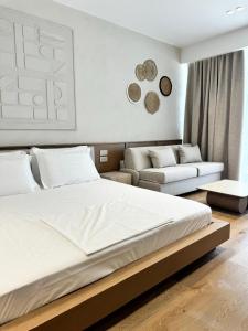 博尔什Ciao Borshi Boutique Hotel的带一张大床和一张沙发的卧室