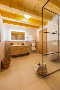 a bathroom with a sink and a mirror at Graf Chiemo Suites - direkt am Chiemsee mit separatem Seezugang in Chieming