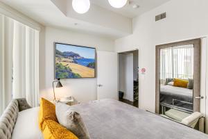 a bedroom with a large bed and a window at Luxe Long Beach Condo with Pool 1 Mi to Shoreline! in Long Beach +30 photos