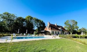a house with a swimming pool in front of it at Le Presbytere de Leyrat in Leyrat