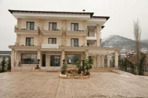 a large building in front of a mountain at Diamond River Resort & Spa in Kastoria