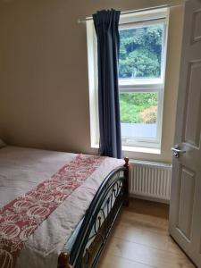 a bedroom with a bed and a window at A memorable place in London, Plaistow in London