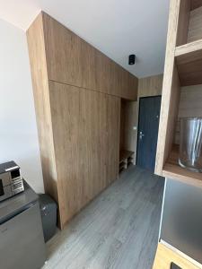 a kitchen with wood paneling and a counter at Apartmán na Liptove in Liptovský Mikuláš +5 photos