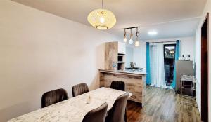 a kitchen and dining room with a table and chairs at Le Bouchon Public Beach Apartment in Bouchon