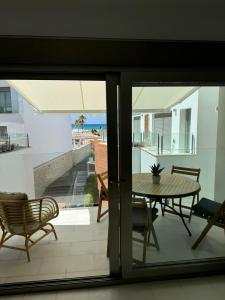a view of a patio with a table and chairs at REf 107 DUPLEX DUNA PLAYA ZAHARA in Zahara de los Atunes