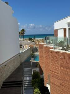 a view of the beach from the balcony of a building at REf 107 DUPLEX DUNA PLAYA ZAHARA in Zahara de los Atunes