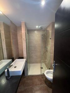 a bathroom with a shower and a sink and a toilet at REf 107 DUPLEX DUNA PLAYA ZAHARA in Zahara de los Atunes +6 photos