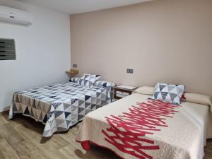 two beds sitting in a room at Casa Soro Ayna in Ayna