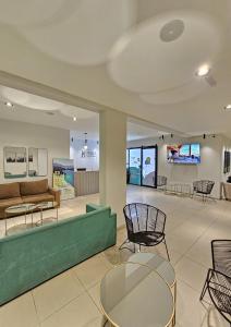 a lobby with a couch and chairs and tables at M382 Hotel Bariloche in San Carlos de Bariloche