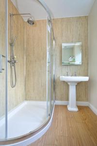 a bathroom with a shower and a sink at Craig Y Glyn in Pwllheli